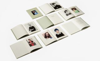 Rows of open books with photo's of people in them.