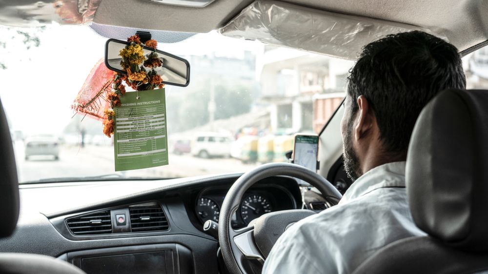 An uber driver seen from the backseat 