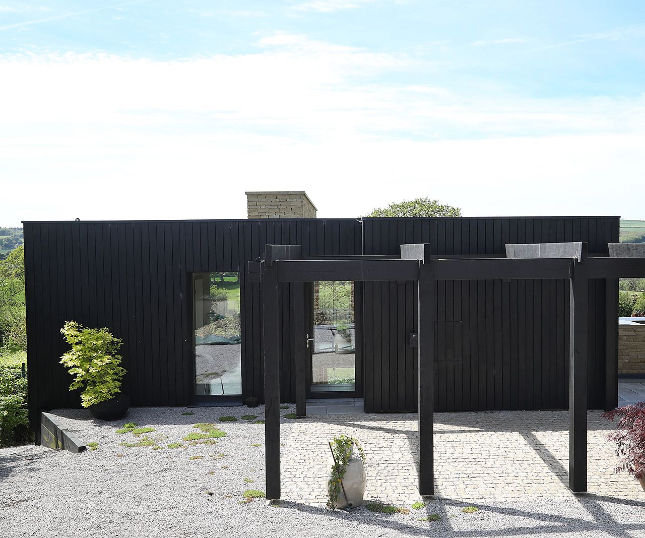View of the front of a self build home. Though it appears to be a single storey there is a lower second level.