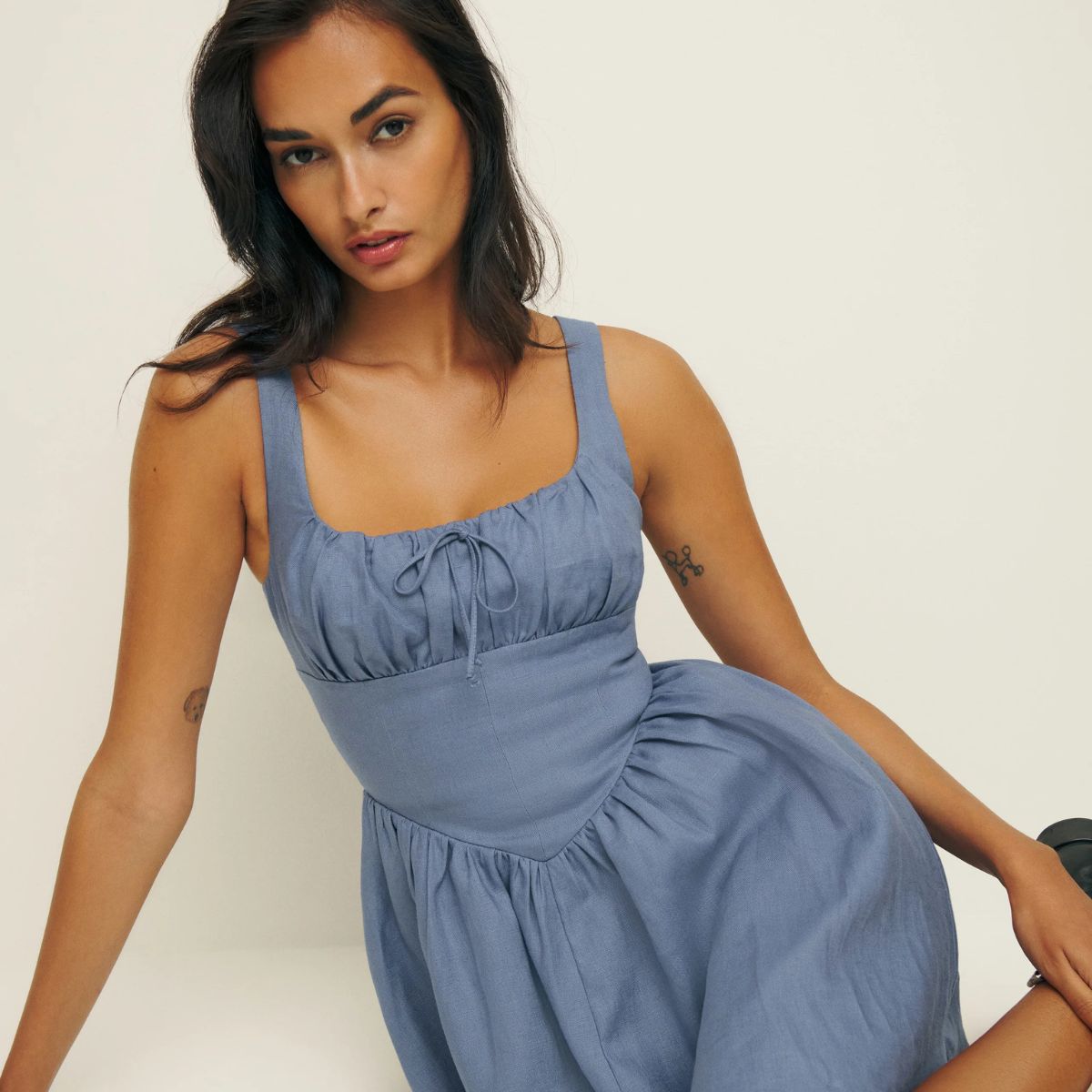 Woman wears blue linen dress