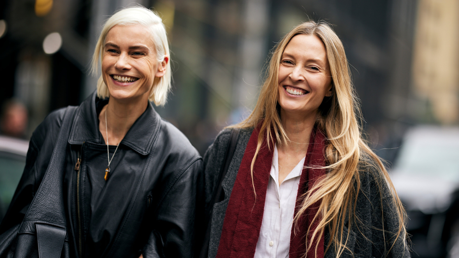 two mature women with bare skin wearing black jackets