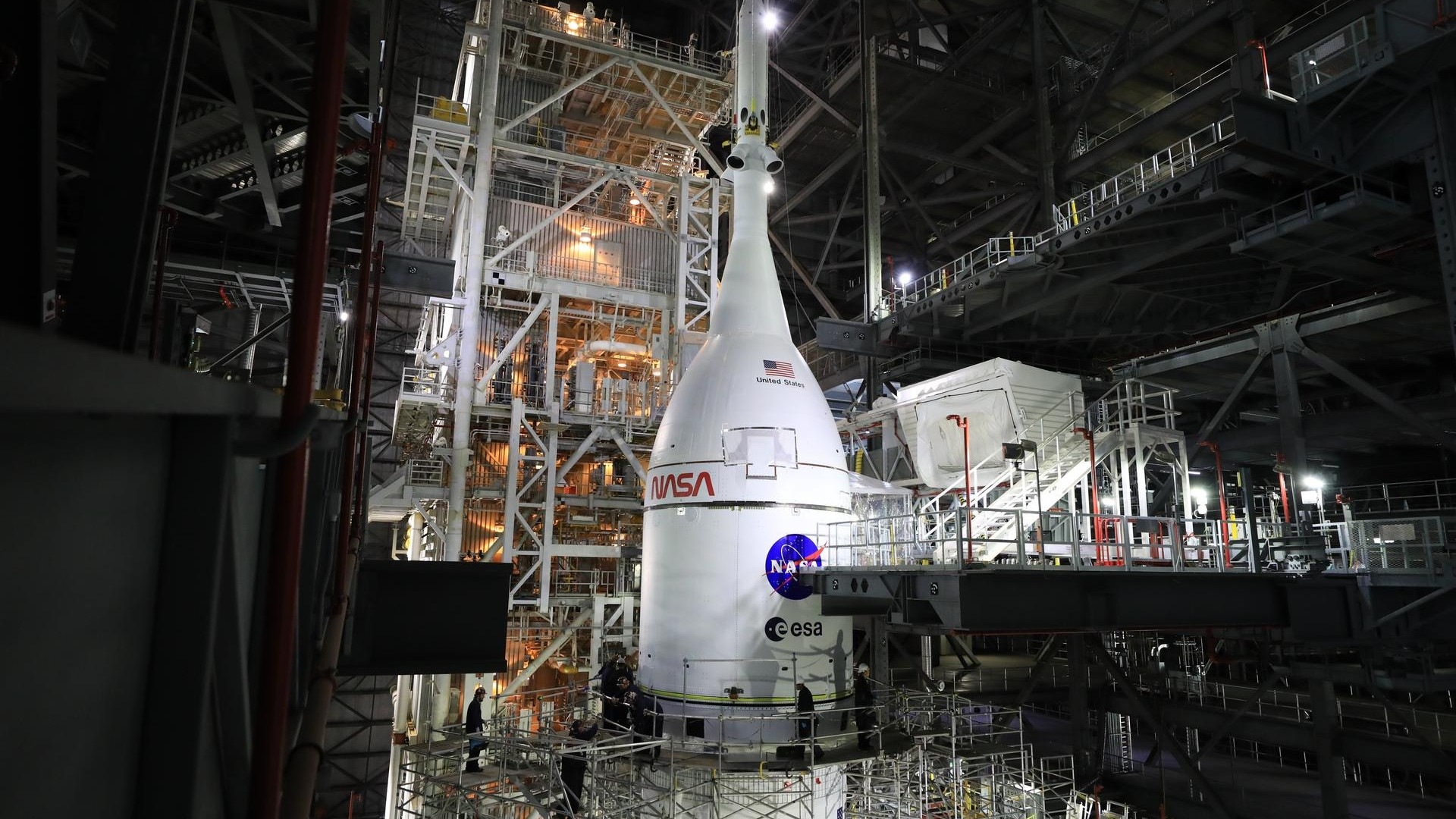 a rocket stands upright in a hangar