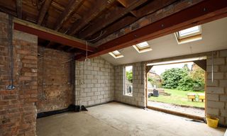 wooden roof with brick wall with white wall