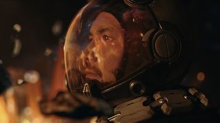 Man in a spacesuit looking at fire