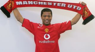 MANCHESTER, ENGLAND - JANUARY 10: Patrice Evra of Manchester United poses after signing for Manchester United at Carrington Training Ground on January 10, 2006, in Manchester, England. (Photo by John Peters/Manchester United via Getty Images)