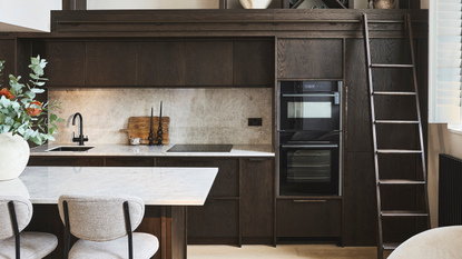 dark wood small kitchen with a ladder