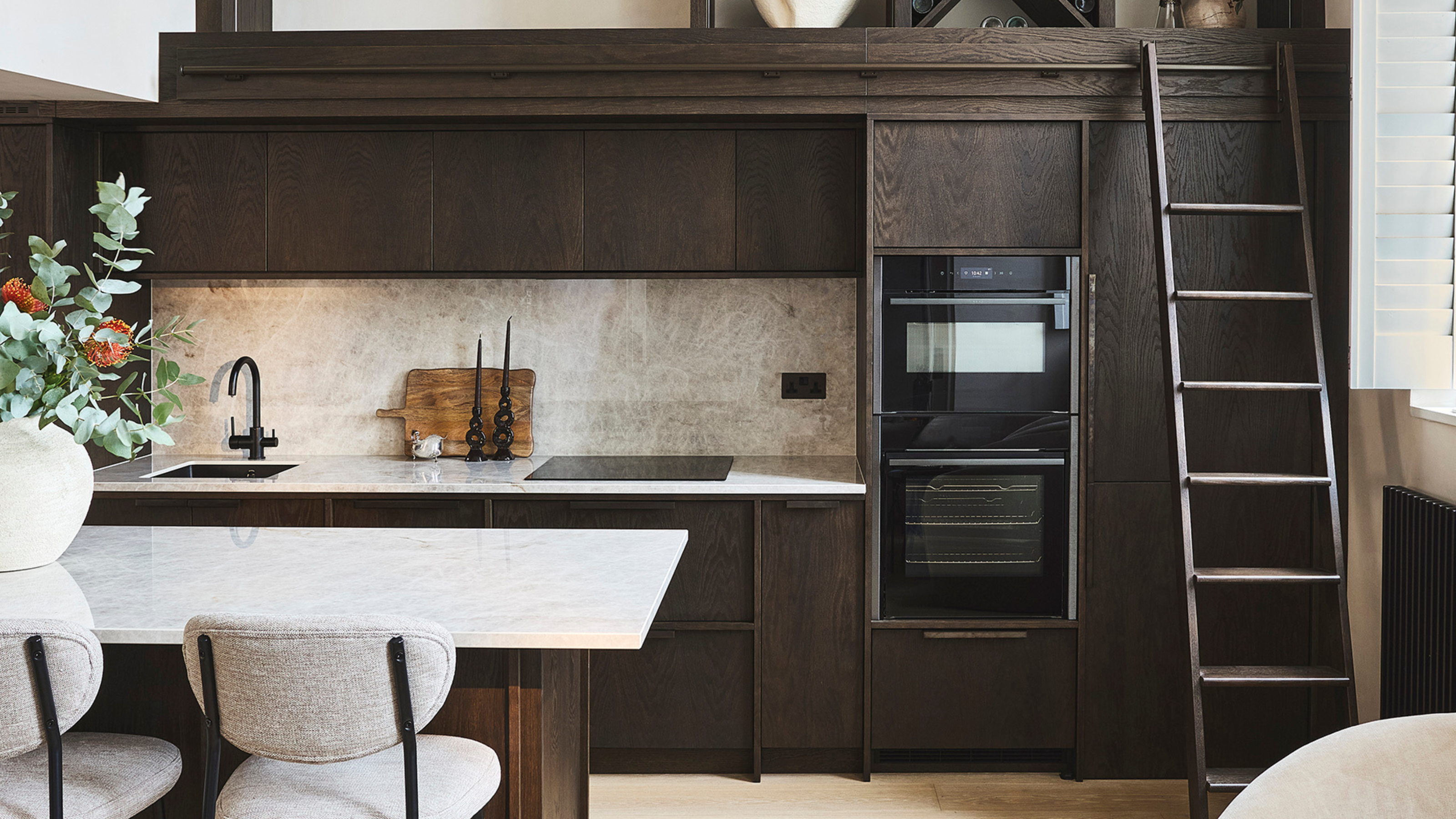 dark wood small kitchen with a ladder