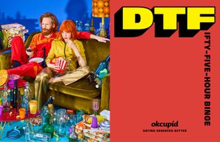 View of an OKCupid ad with a half blue, half red background. On the blue side, there is a couple sitting on a dark green sofa with popcorn and a remote control. They are surrounded by multiple pizza boxes, cups and bottles. And on the red side, there is text that says 'DTFifty-Five-Hour Binge'