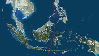 A satellite image of Indonesia with a dotted red line running through the middle