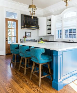 blue and white kitchen with wooden flooring