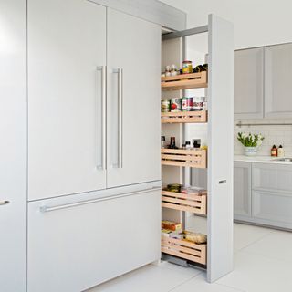 white kitchen with pull out wooden cabinet