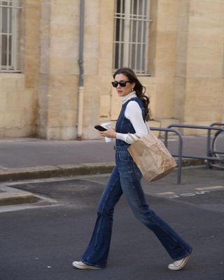 Dark flared denim jumpsuit with Converse