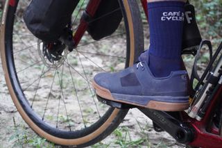 Image shows Anna wearing the Crankbrothers Stamp lace shoes on a gravel bikepacking trip.