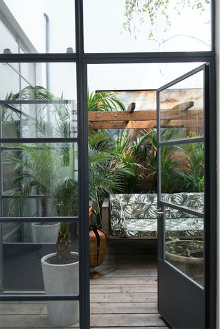small garden ideas with crittall doors and palm print