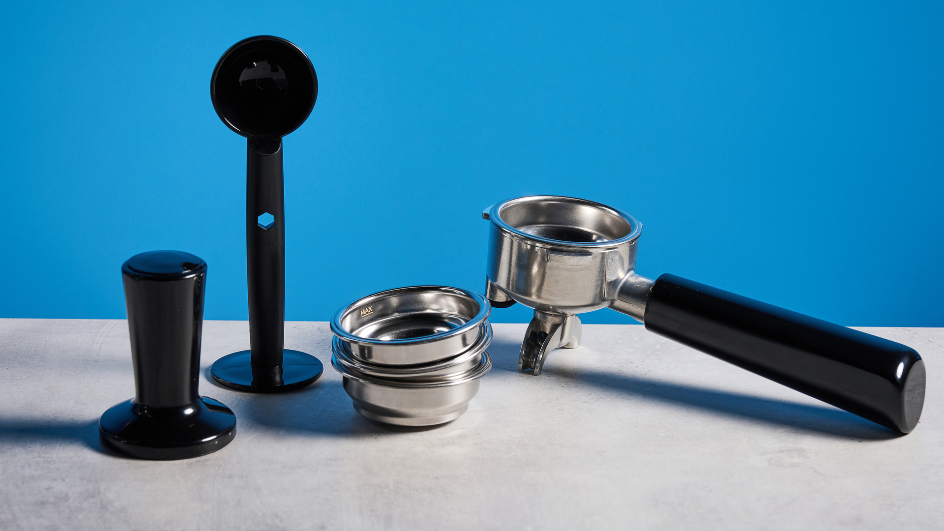 the casabrews ultra espresso machine with 20 bar pressure, a steam wand, LED screen, timer, and tamper accessories, photographed against a blue background