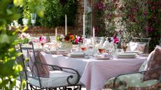 garden table with iron chairs and candles and lanterns