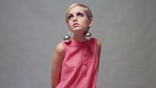 British Model Twiggy, (Lesley Hornby) wearing a pale pink mini dress and large 'bauble' earrings, 3rd December 1966.
