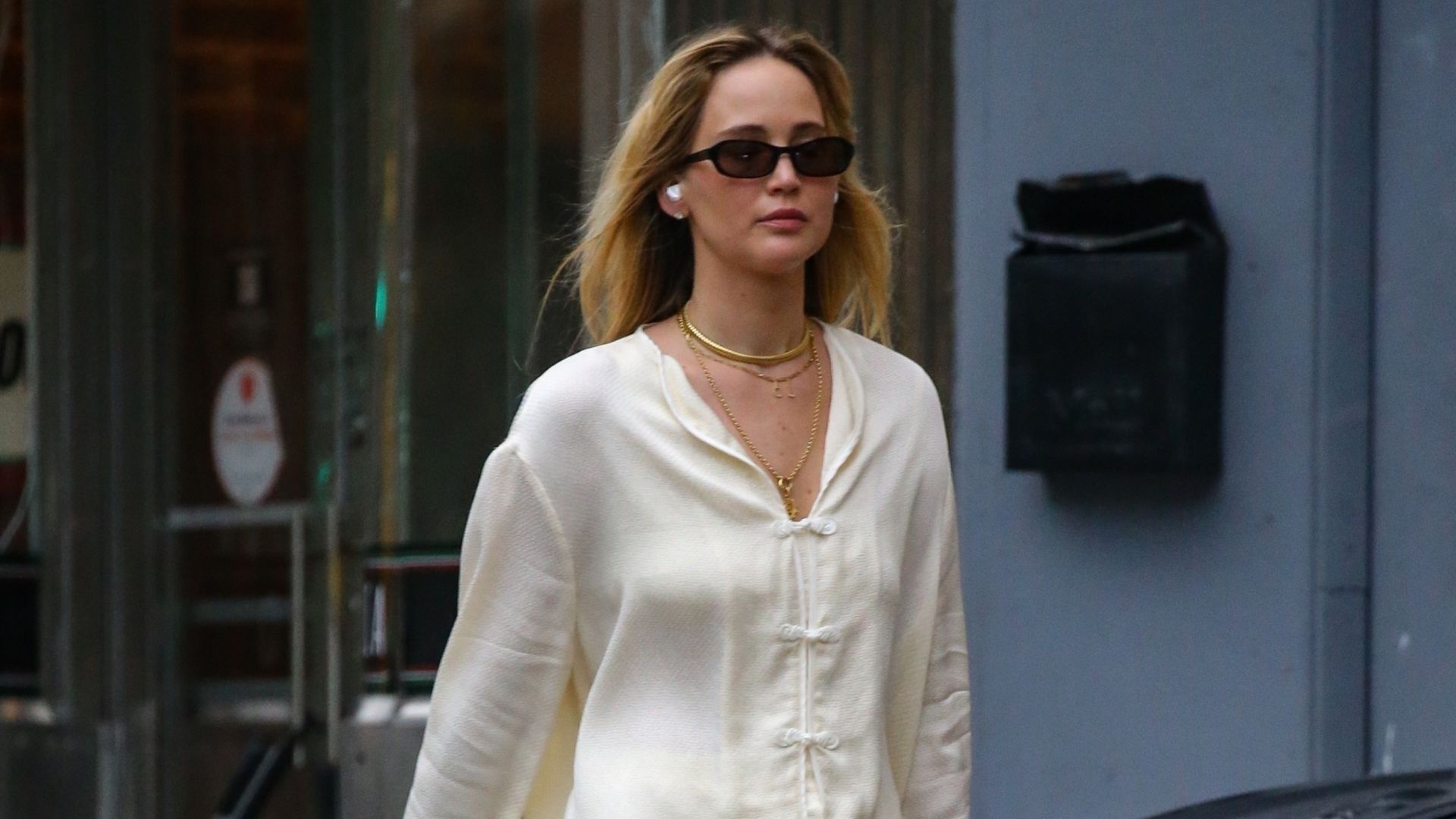 Jennifer Lawrence walks down the streets of New York wearing a cream satin two-piece with mesh ballet flats and a Dior Saddle bag.