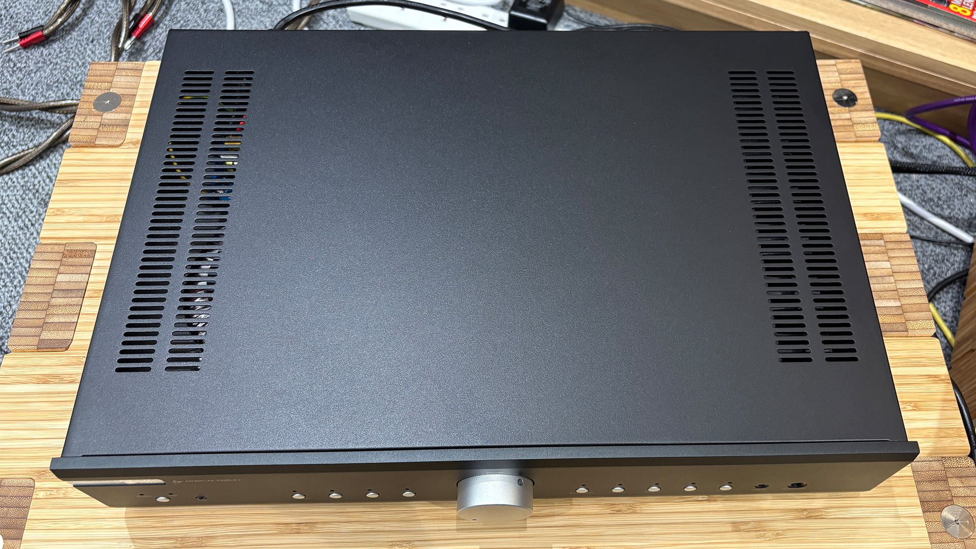 Musical Fidelity B1xi integrated amplifier on wooden hi-fi rack in front of bookcase top-down view