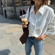 Marianne Smyth wears a white button down and jeans