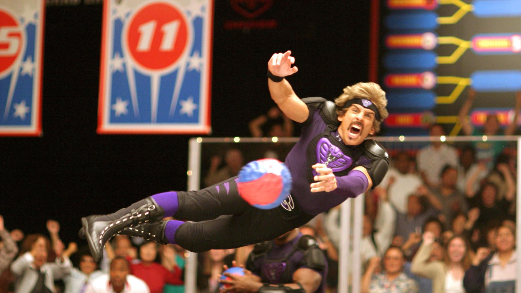 Ben Stiller as White Goodman diving and throwing a dodgeball in Dodgeball: A True Underdog Story