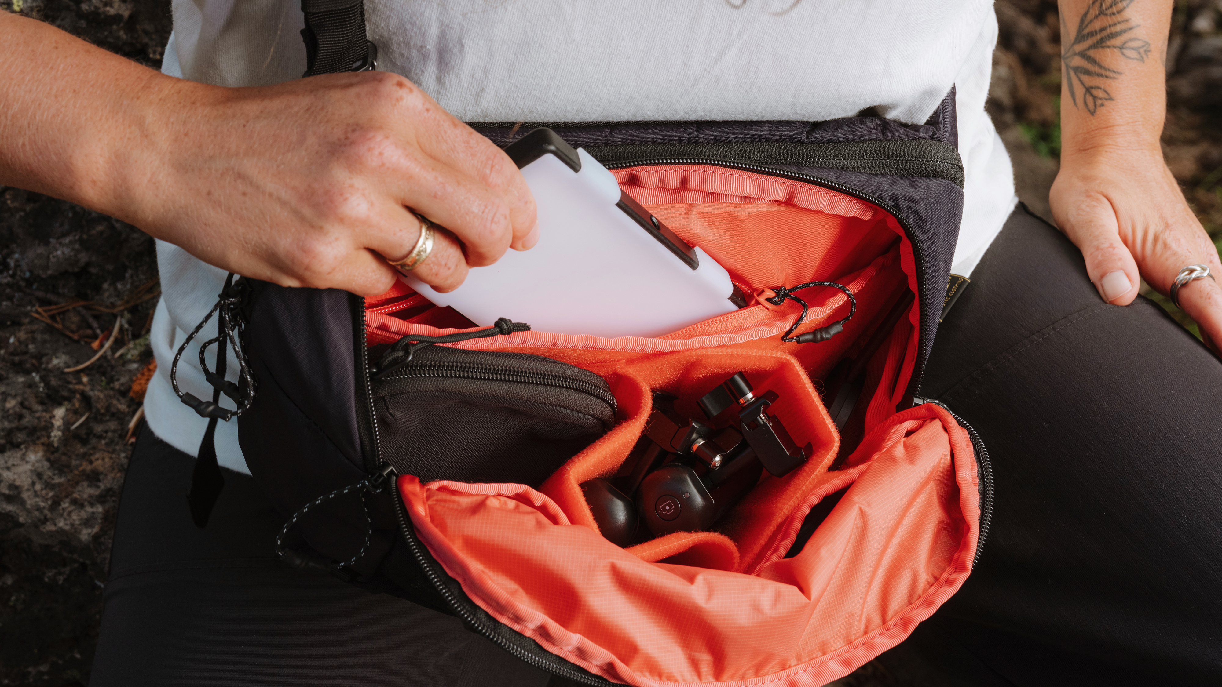 A photographer using the Moment Balance sling in the black colorway