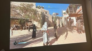 Assassin&#039;s Creed Mirage running from a BenQ X3100i projector on a white wall