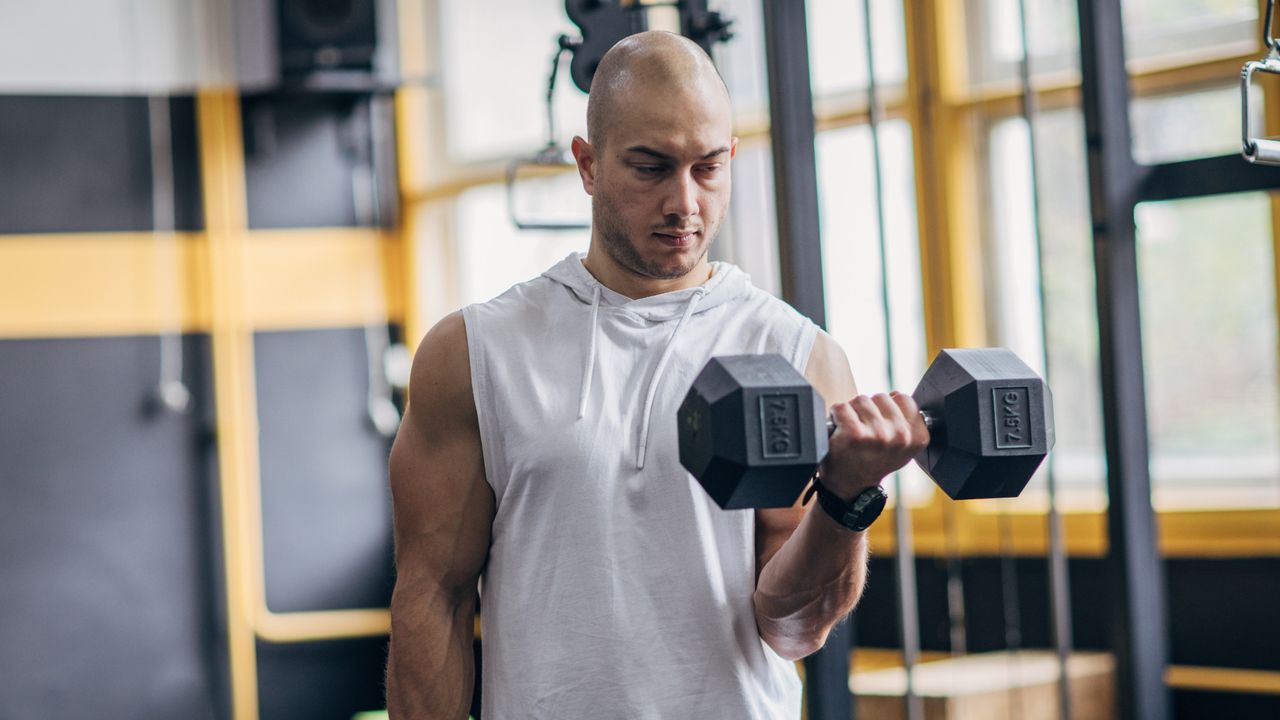 Man performing biceps curls with dumbbells