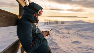 Man using phone in snowy conditions