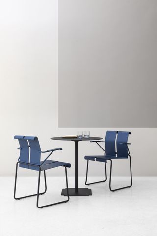 Small bistrot table with two blue dining chairs