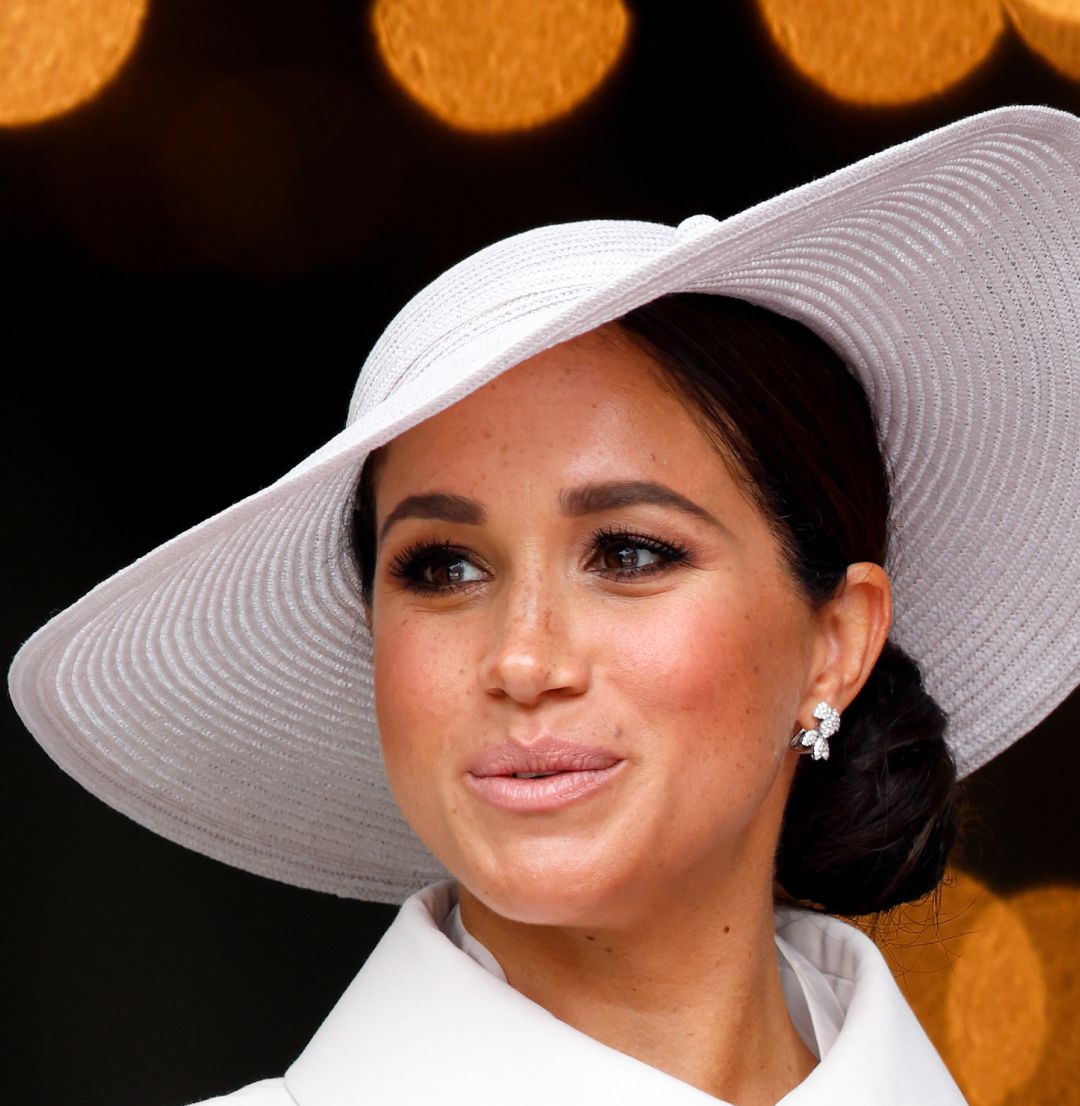 Meghan Markle wearing a white hat and coat