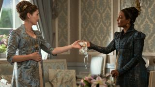 (L to R) Ruth Gemmell as Violet Bridgerton holding a white cloth with Adjoa Andoh as Lady Agatha Danbury.