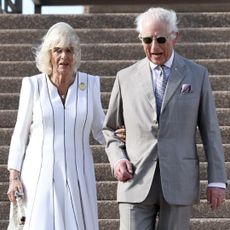 Queen Camilla and King Charles walk down the steps at Sydney Opera House, which Meghan Markle and Prince Harry did in 2018