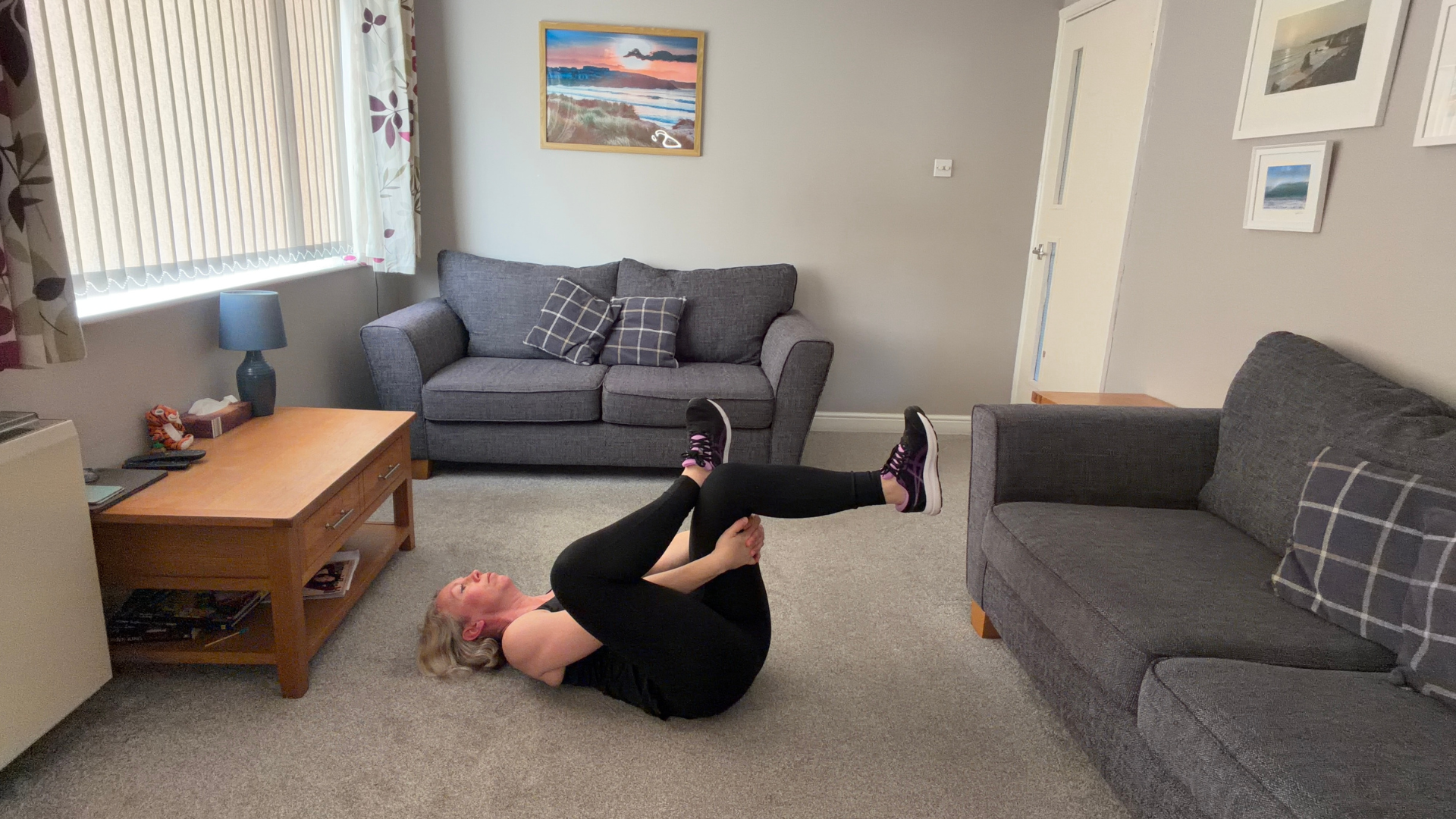 Personal trainer Becky Fuller performing stretching demonstrations in a living room