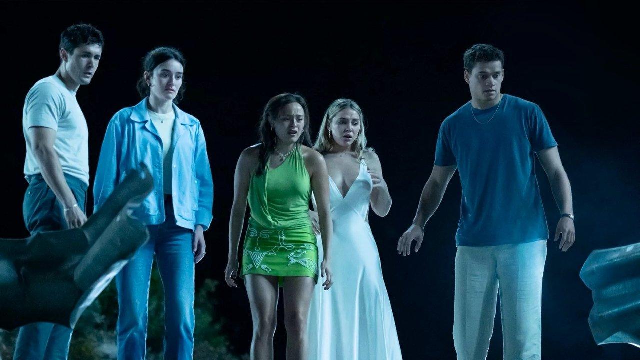 Three guys and two girls looking shocked at the side of a road at night in 2025&#039;s I Know What You Did Last Summer