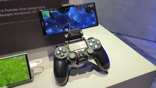 A DualShock 4 controller with a phone attachment