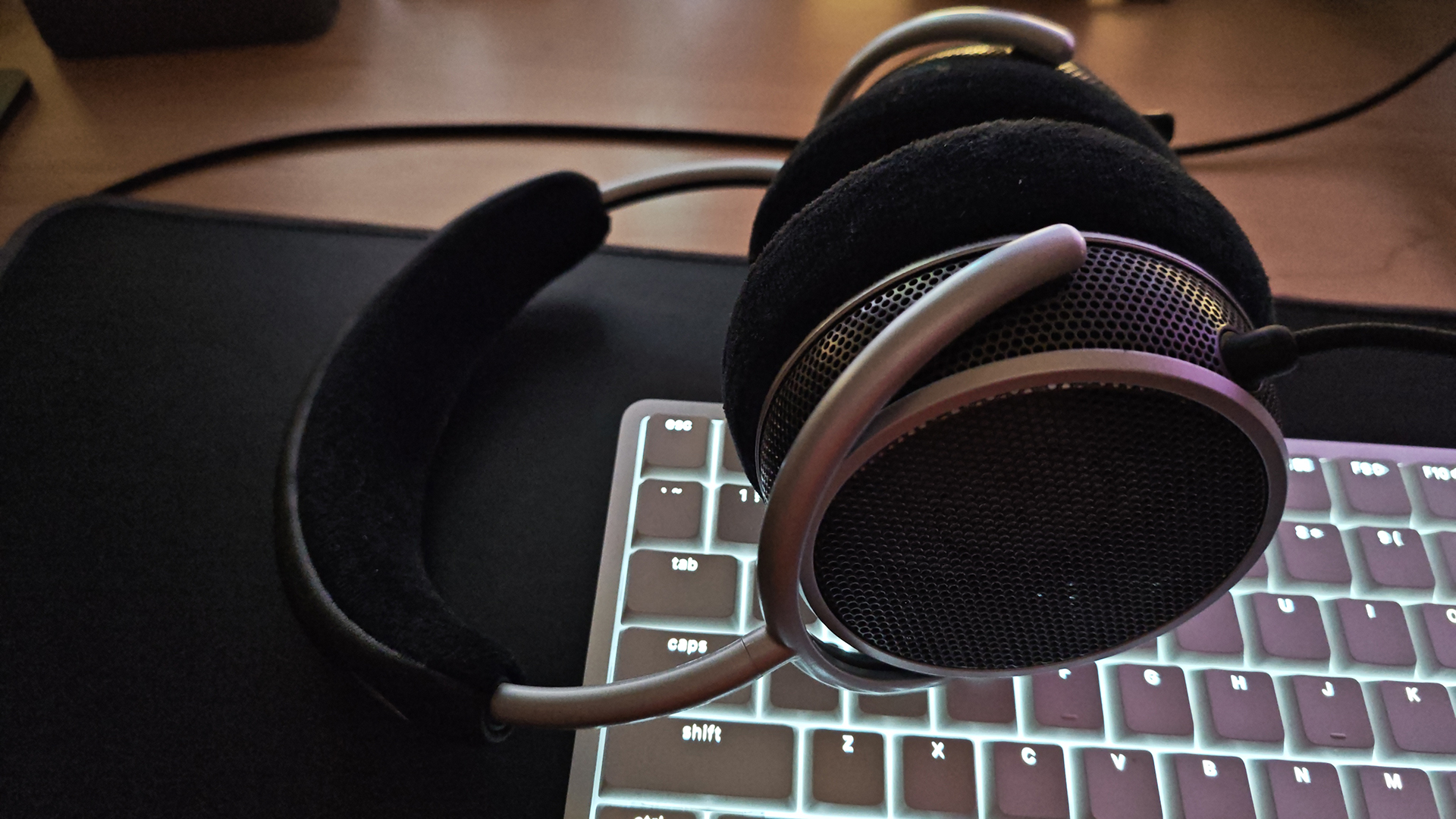 The Grell OAE2 headphone on a white, backlit keyboard.