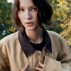 Woman wearing khaki and dark brown Zara barn coat jacket.