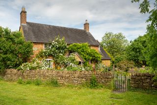 Cottage and cottage garden seen from neighbouring field