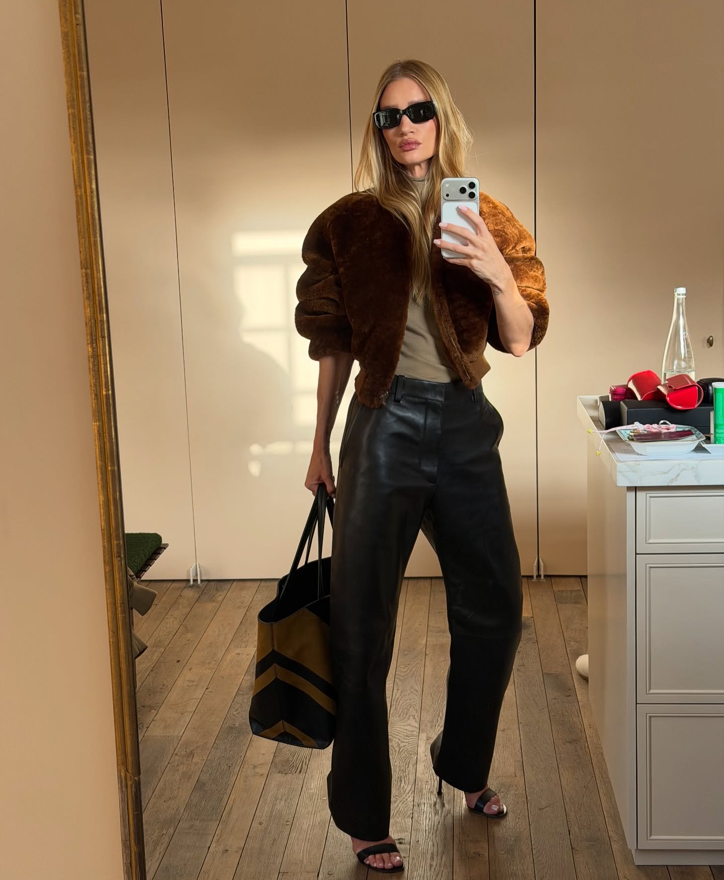 An image of @rosiehw wearing a pair of leather trousers from Bottega Veneta with a suede bomber jacket from Phoebe Philo.