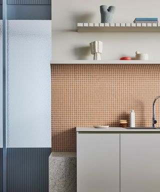 modern kitchen orange tiles blue walls open shelves