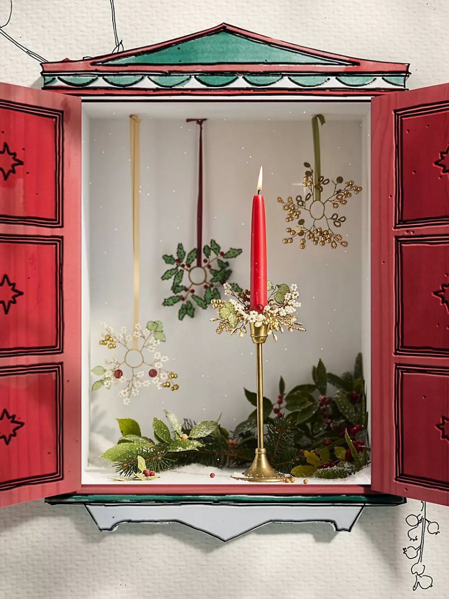 Red taper candle with a gold holder and a sparkling candle cuff