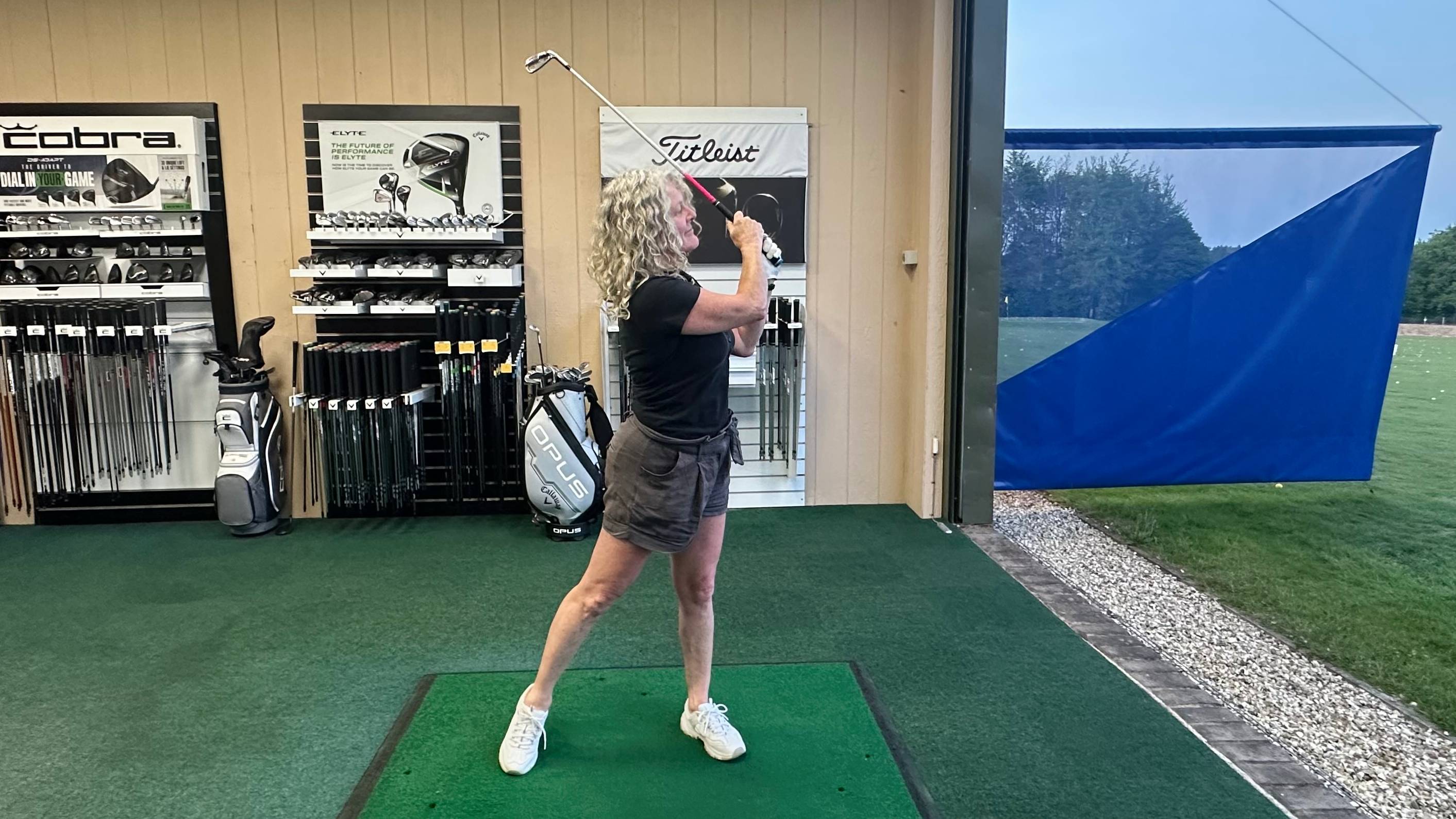 Female golfer using a 7-iron with a custom fit grip