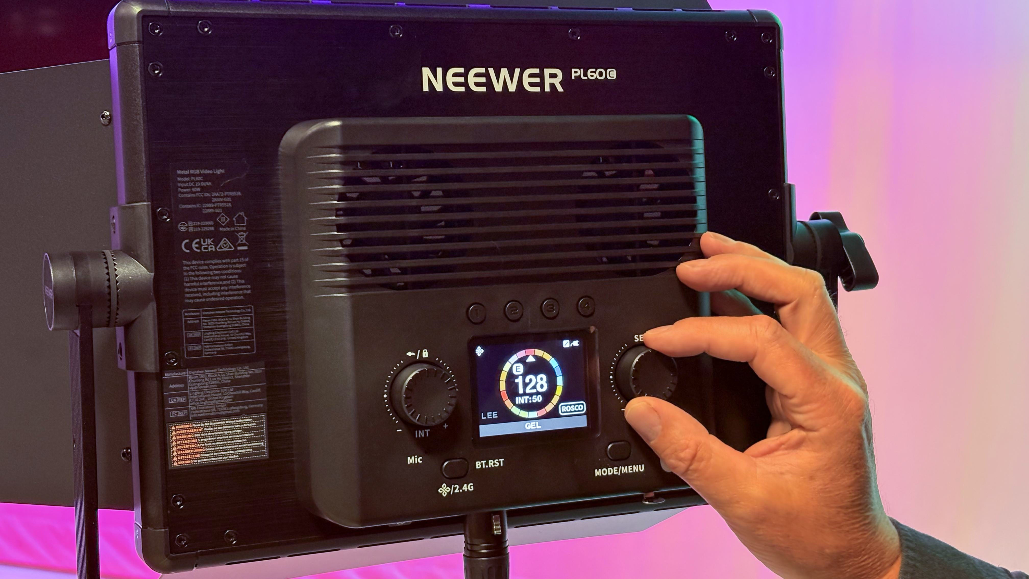 Shot of the display showing a collection of colour gels on a circular interface. A finger twiddle the right control knob to dial on a specific colour gel