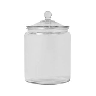 A large glass jar with lid with a circular handle