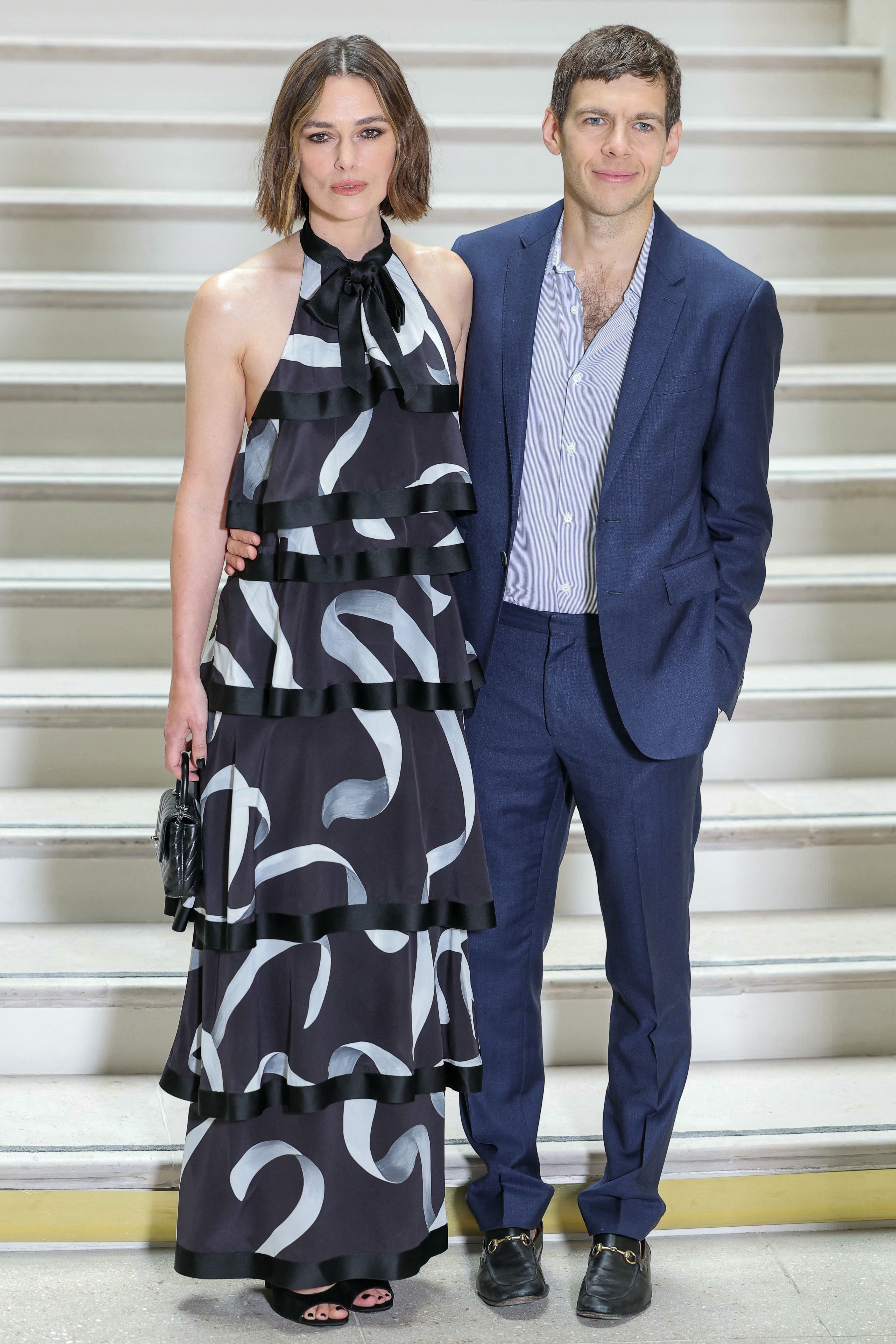 Keira Knightley and her husband British musician James Righton pose upon arrival ahead of the Chanel's Haute-Couture Fall/Winter 2025-26