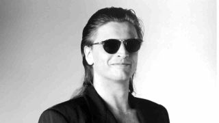 Kingdom Come’s Lenny Wolf in sunglasses and a suit