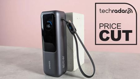 The Anker Laptop Power Bank against a stand in a pink room during our review, with a black TechRadar badge that reads 'Price Cut'
