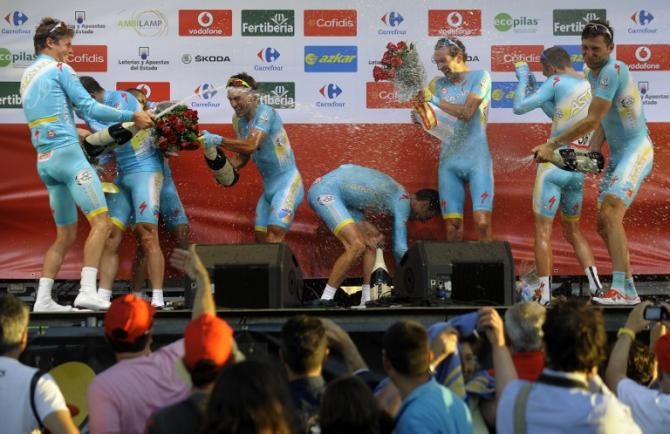Astana celebrates with champagne on the podium