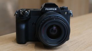 The Fujifilm GFX50S II on a wooden table